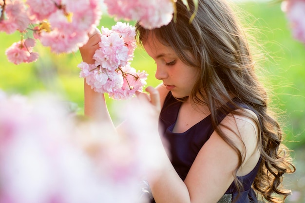Cute girl amid cherry flowering