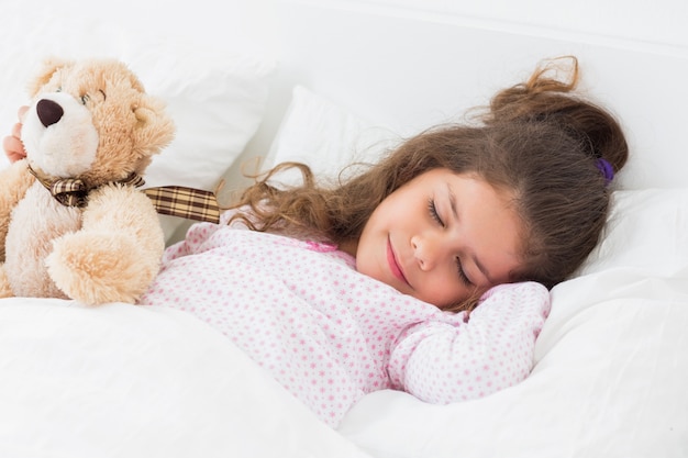 cute girl asleep with teddy bear