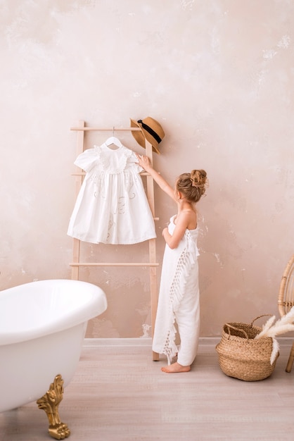 A cute girl in a big white towel is about to dress up