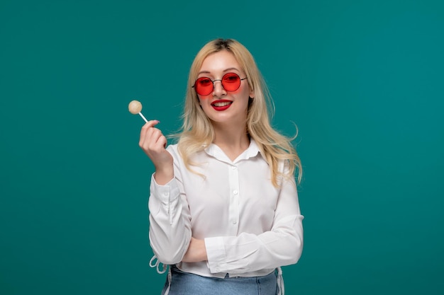 Cute girl blonde beautiful young girl in a white neat shirt excited for summer