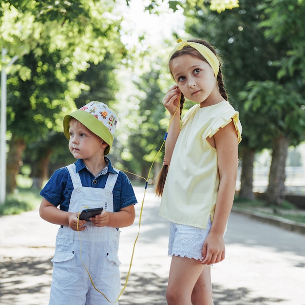 Cute girl and boy listening to music