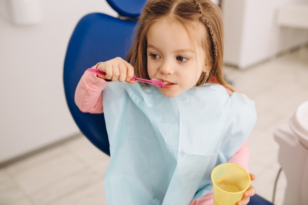 Cute girl brushing teeth dentistry