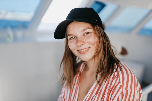 cute girl in a cap on vacation in a sea trip on a yacht resort vacation concept