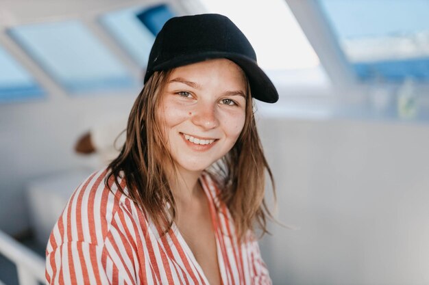 cute girl in a cap on vacation in a sea trip on a yacht resort vacation concept