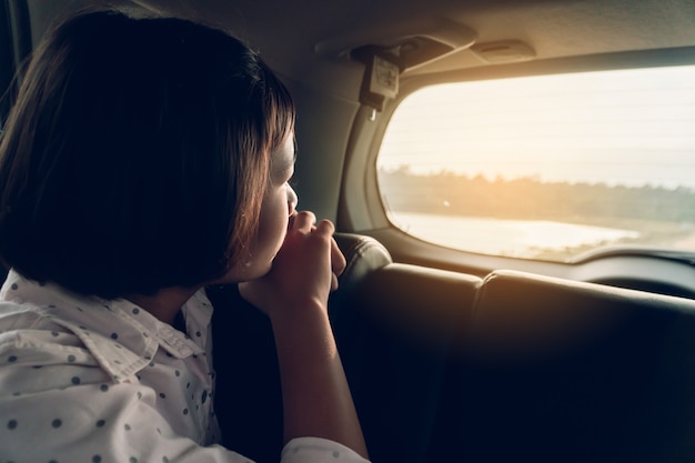 Cute girl in car traveling on holiday