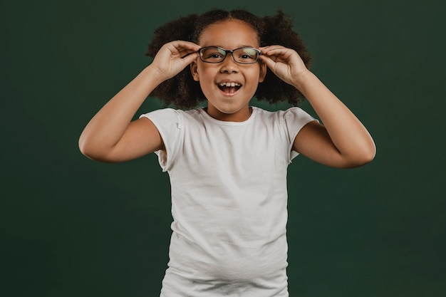 Cute girl child arranging her glasses