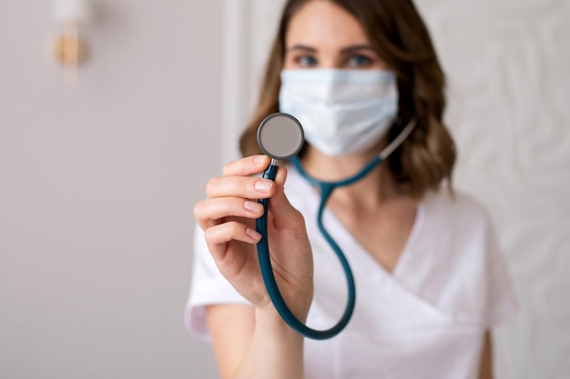 Cute girl doctor shows a stethoscope