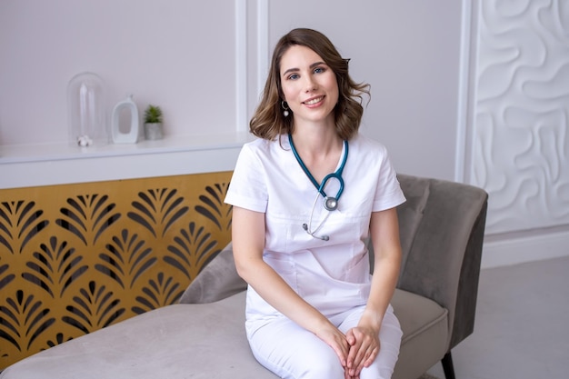 Cute girl doctor sitting at a table with a stethoscope