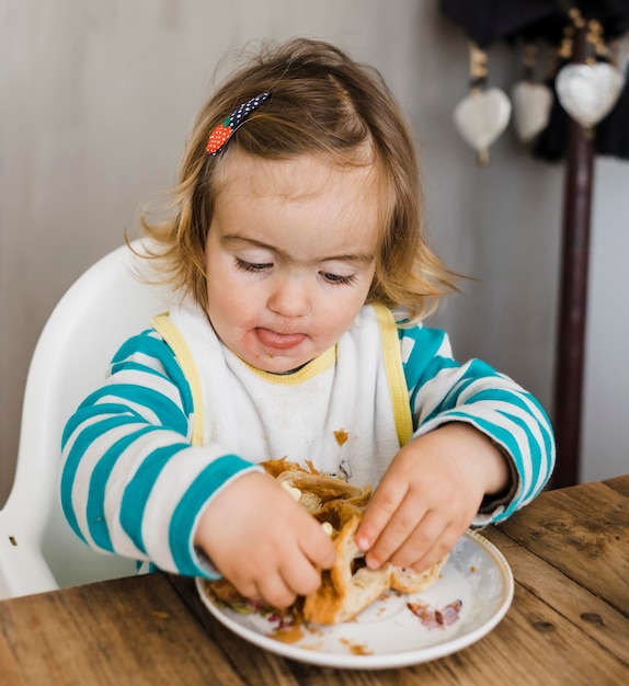 Cute girl eating at table