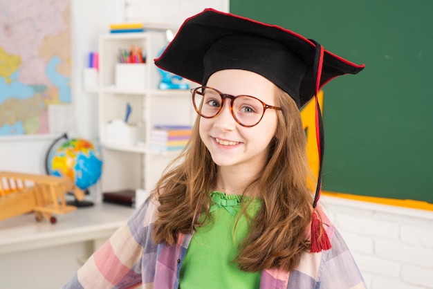 Cute girl in elementary school in university cap