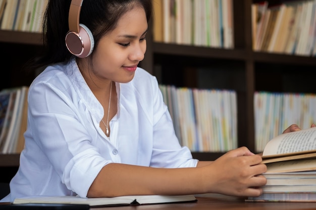 cute girl enjoys listens to music in headphones in home