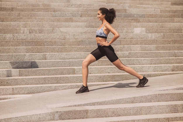 Cute girl exercising outside and looking involved