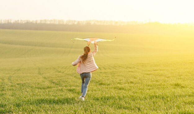 Cute girl flying bright kite