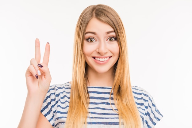 Cute girl gesturing with two fingers