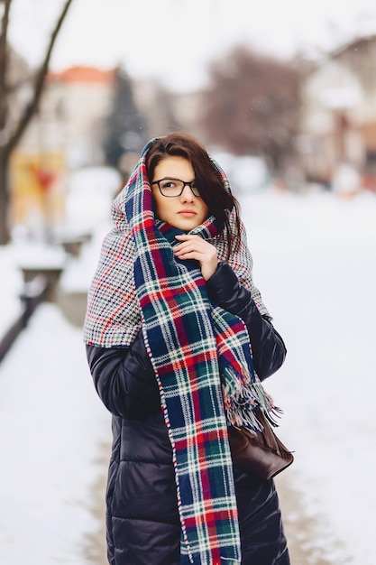 Cute girl in glasses and a scarf