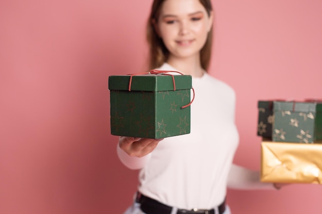 Cute girl holding gift boxes and laughing