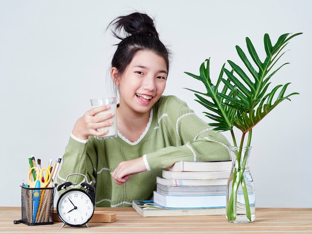 Cute girl holding glass of milk.