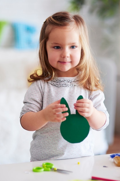 Cute girl holding handmade easter decorations