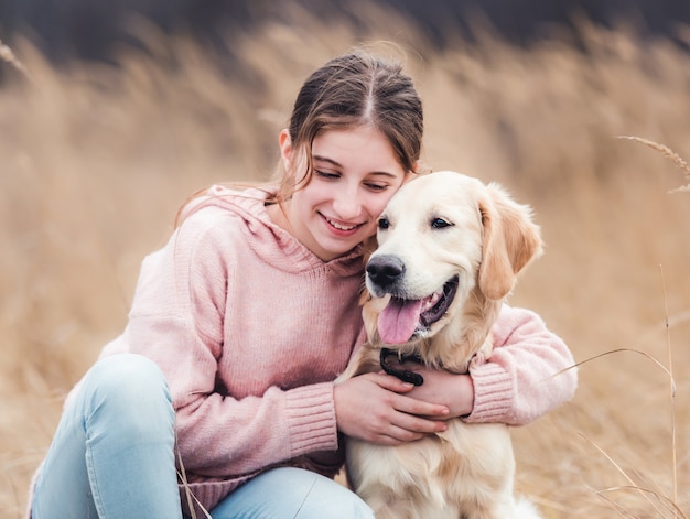 Cute girl hugging golden retriever