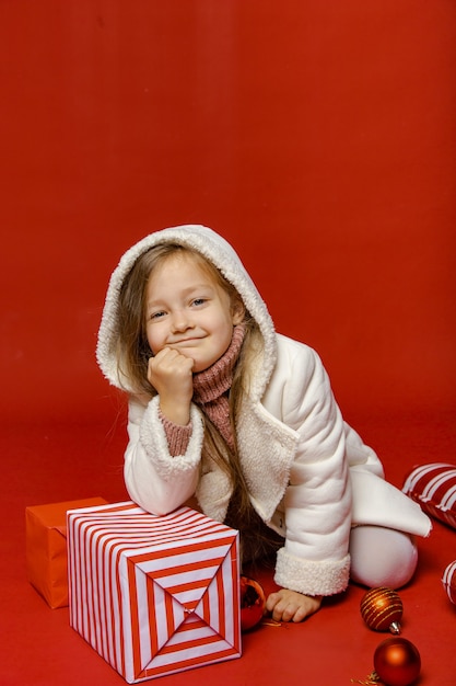 Cute girl is preparing for the new year in the background with gifts