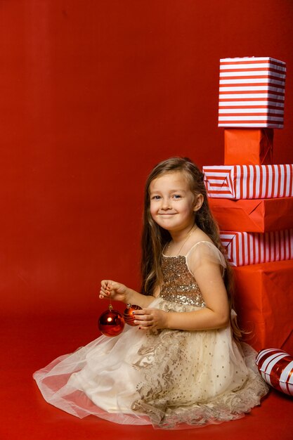 Cute girl is preparing for the new year in the background with gifts