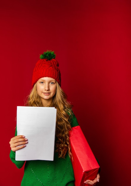 Cute girl is preparing for the new year in the background with gifts