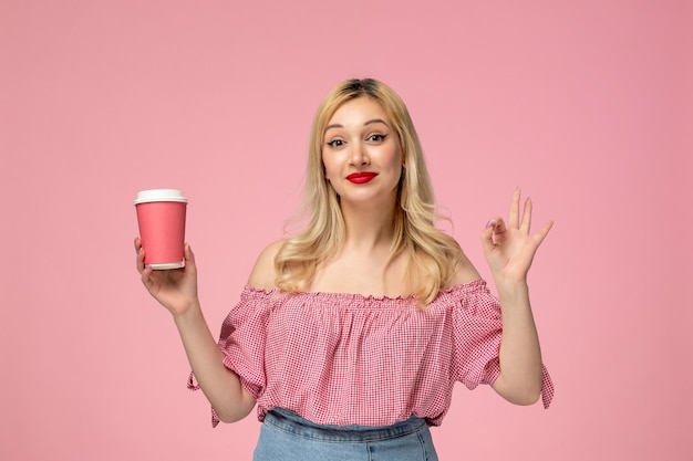 Cute girl lovely young lady with red lipstick in pink blouse confident with pink coffee cup