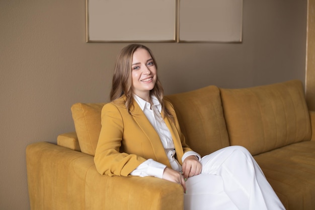 Cute girl in the office sitting on the couch