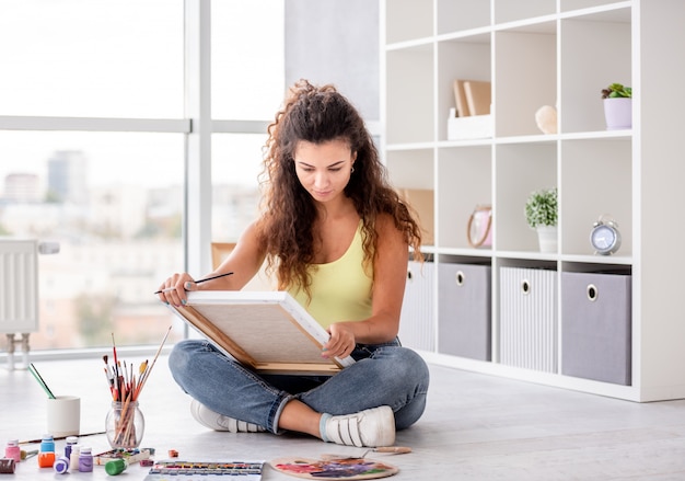 Cute girl painting in workshop