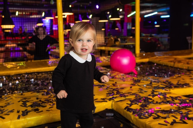 Cute girl playing on mats during party