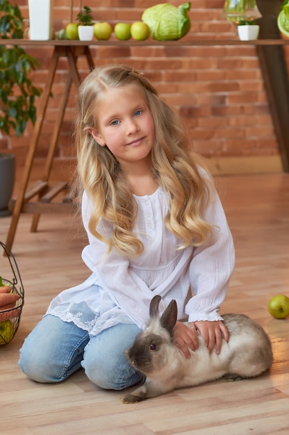Cute girl playing with rabbit