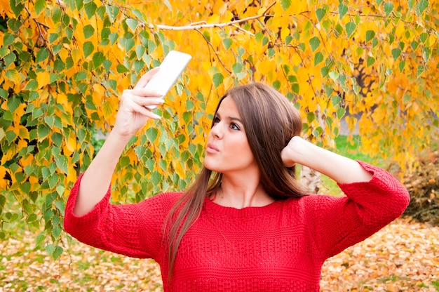 Ragazza carina in posa per selfie tra natura