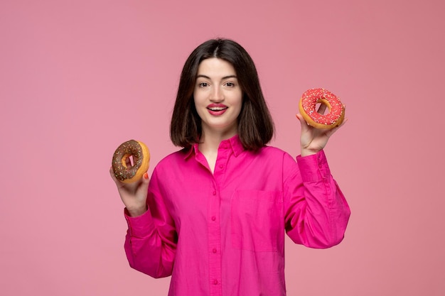 Cute girl pretty adorable girl in pink shirt with red lipstick with a pair of donuts