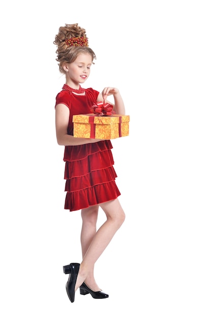 Cute girl in red dress holding gift box