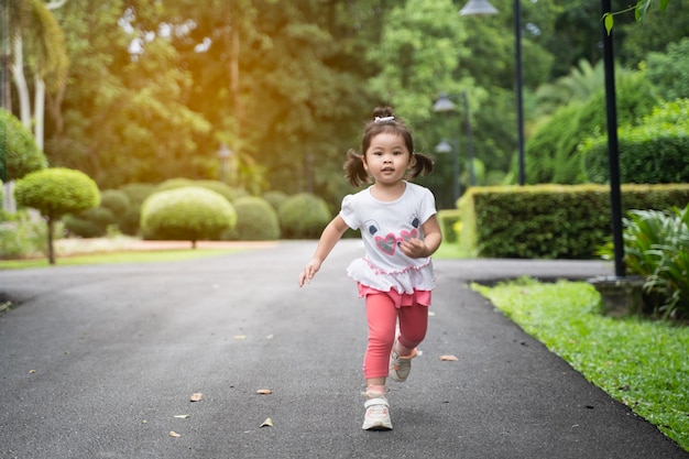 Cute girl running at the garden