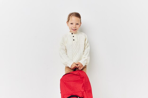 Cute girl school backpack with a hat on his head Lifestyle unaltered