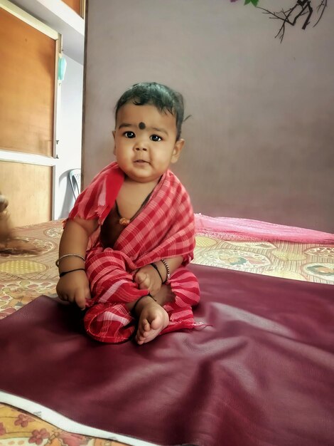 Cute girl sitting on bed at home