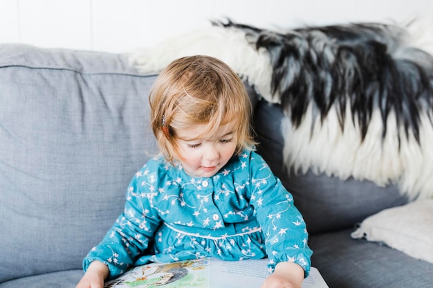 cute girl sitting on sofa at home