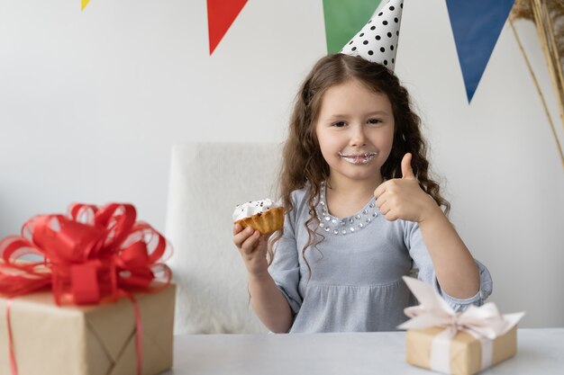 Cute girl sitting at the table.