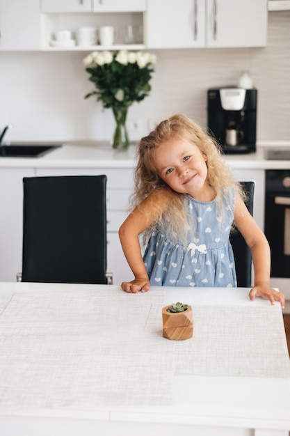 Cute girl smiling and waiting on the kitchen