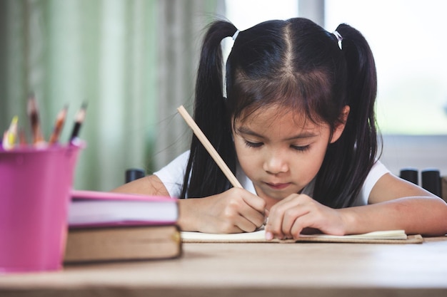 Photo cute girl studying in classroom at school