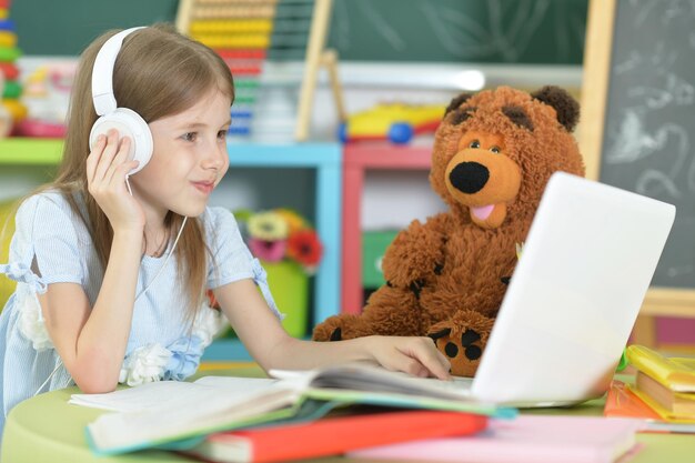 Cute girl using laptop at home while studying