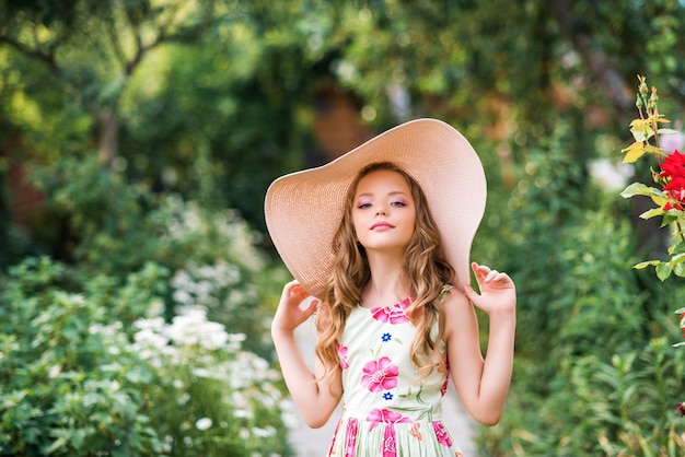 Cute girl walks in the summer garden