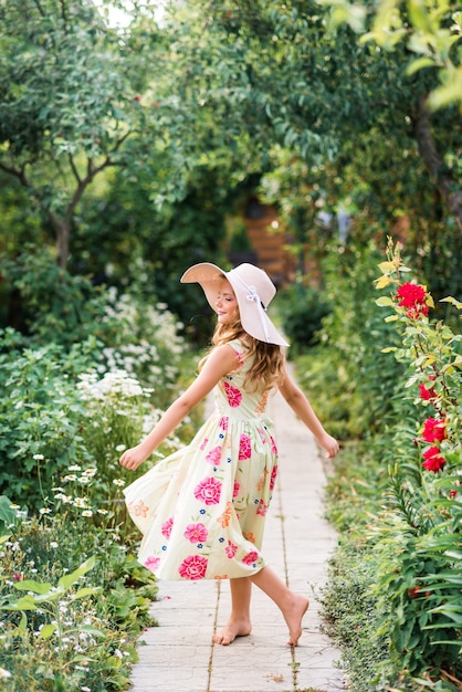 Cute girl walks in the summer garden