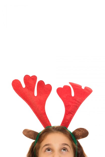 Photo cute girl wearing christmas antlers