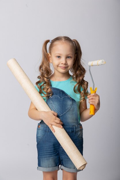 Cute girl on a white background with construction tools