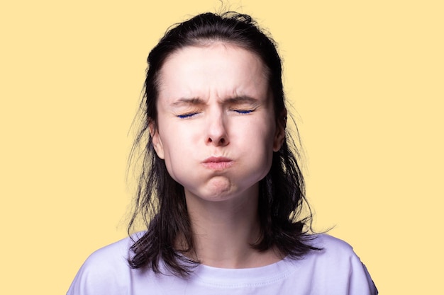 cute girl in a white fetball cap on a yellow background