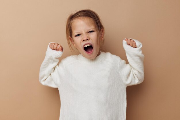 Cute girl in white sweater posing hand gestures childhood unaltered