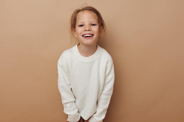 Cute girl in white sweater posing hand gestures isolated background