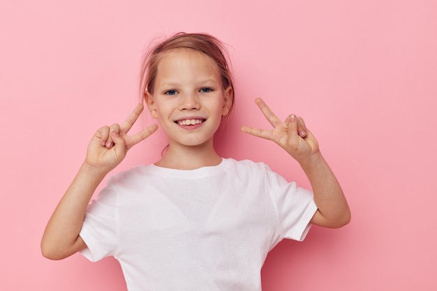 白いTシャツのかわいい女の子は変更されていない子供時代の笑顔